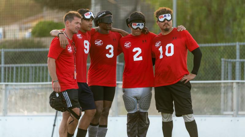 Five male athletes wearing a red T-shirt